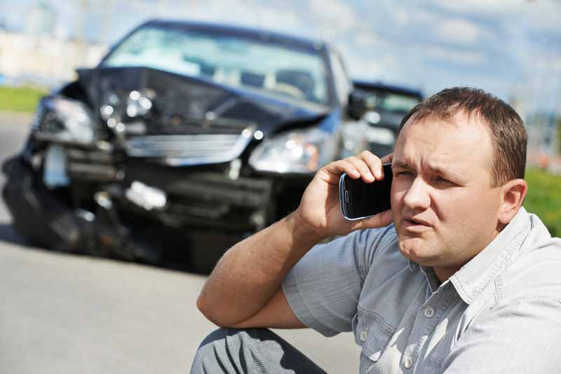 Cartoon depiction of a man holding a sign that says 'Best car accident attorney near me'