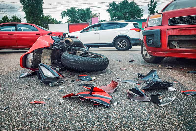 car crash, broken and wrecked motorcycle on road