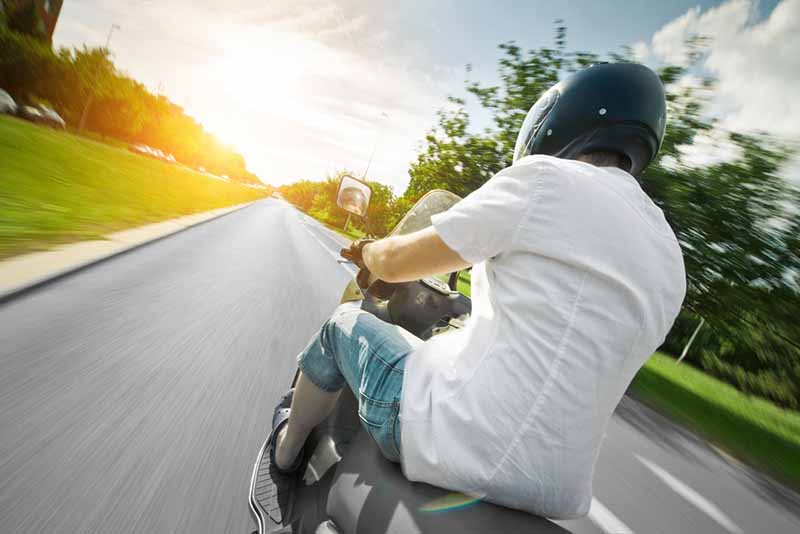 man riding a motorcycle on a highway